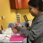 Mom changing baby's diaper